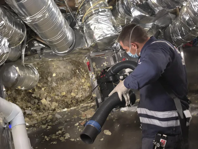 Wrentham Air Duct Cleaning specialist operating negative pressure cleaning equipment for thorough duct maintenance in Wrentham
