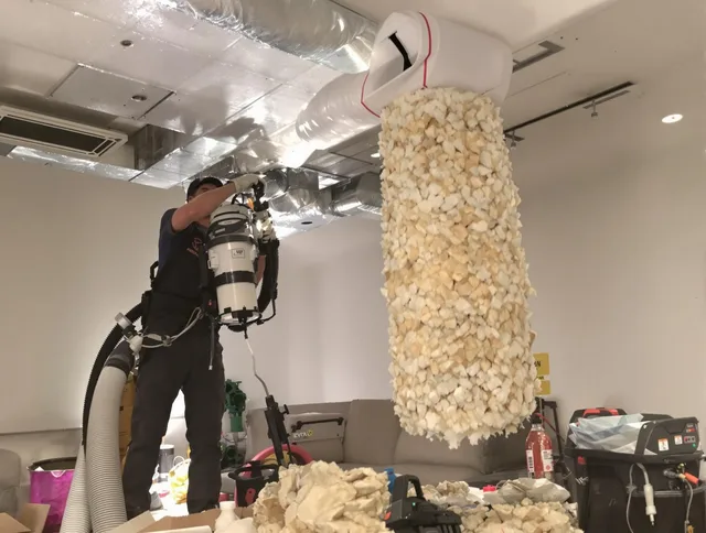 Wrentham Air Duct Cleaning technician performing precision vacuum insulation removal in a residential property in Wrentham